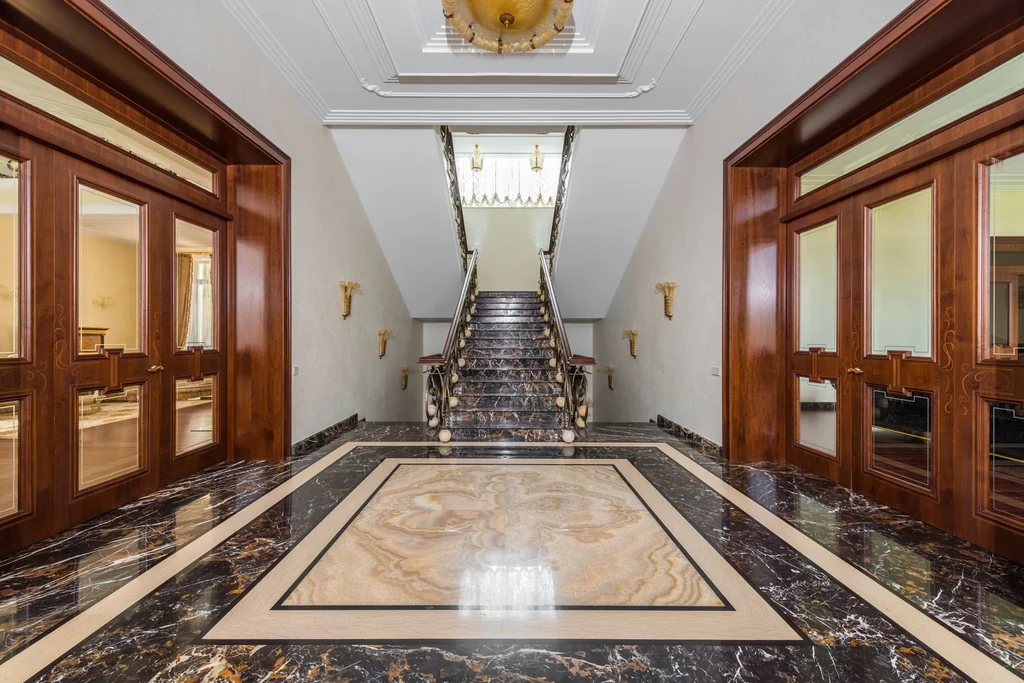 Polished marble floor with inlaid border in a luxury hallway