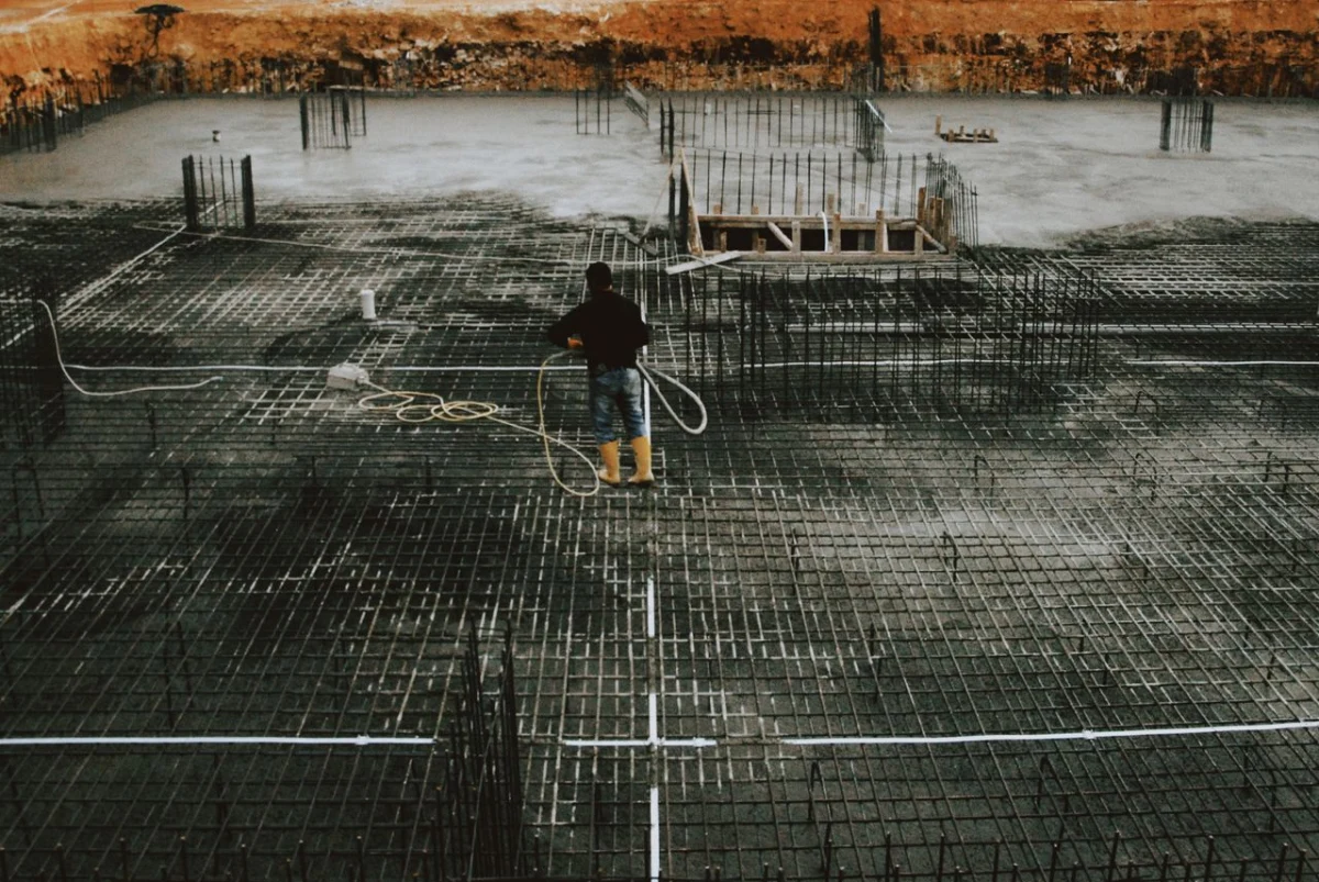 Worker on a reinforced concrete foundation before the pour